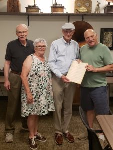 This a photo of Larry and his wife Caroline, Mike Parkinson, and Chuck Haddix, Curator of the Marr Sound Archive at UMKC. The music is by Dr. Carroll Lewis from a jazz band chart he wrote. Thanks to Larry, all of Carroll's jazz band pieces are in Special Collections at the UMKC Library. 